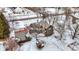 Aerial view of a house featuring a stone chimney, wooden siding and pergola, nestled in a snowy landscape at 1307 W 161St St, Westfield, IN 46074