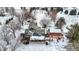 Aerial shot of a beautiful home, highlighted by its covered porch, pergola, and the surrounding snow-covered landscape at 1307 W 161St St, Westfield, IN 46074