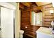 Rustic bathroom features log walls, a shower stall and vanity with solid surface top at 1307 W 161St St, Westfield, IN 46074