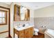 Well-lit bathroom features a wooden vanity with a white countertop, plus tiled walls and floor at 1307 W 161St St, Westfield, IN 46074