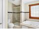 Bathroom featuring glass-enclosed shower, soaking tub, neutral tile, and wood window trim creates a spa-like retreat at 1307 W 161St St, Westfield, IN 46074