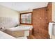 Bright bathroom featuring a soaking tub next to the tiled shower, with a window providing natural light at 1307 W 161St St, Westfield, IN 46074