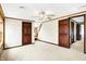 Spacious bedroom with neutral carpet, ceiling fan, and multiple wood doors offer a seamless transition to the rest of the house at 1307 W 161St St, Westfield, IN 46074