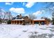 Lovely log home with detached garage and snow-covered grounds at 1307 W 161St St, Westfield, IN 46074