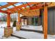 Inviting outdoor living space with wooden pergola and stone supports and a covered porch at 1307 W 161St St, Westfield, IN 46074