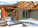 Beautiful log home with a covered porch area, green doors and wooden pergola at 1307 W 161St St, Westfield, IN 46074