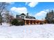 Beautiful log cabin sitting on a snow-covered lot under a cloudy blue sky at 1307 W 161St St, Westfield, IN 46074