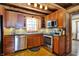 Updated kitchen with stainless steel appliances, tile backsplash, wood cabinets and hardwood floors at 1307 W 161St St, Westfield, IN 46074