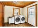 Laundry room with washer, dryer, wood cabinets and plenty of natural light at 1307 W 161St St, Westfield, IN 46074