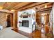 Living room showcases a fireplace, exposed beams, and access to a dining area at 1307 W 161St St, Westfield, IN 46074