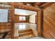 Bright living room features wood floors, log walls and trim and large windows at 1307 W 161St St, Westfield, IN 46074
