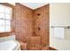 Cozy tiled shower area with bronze hardware and a window for natural light and a place to hang your towel at 1307 W 161St St, Westfield, IN 46074
