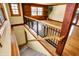 Hardwood staircase with black metal railing and carpet runner descends into a bright living space with natural light at 1307 W 161St St, Westfield, IN 46074
