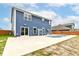 A backyard featuring a blue house, concrete patio, and an inviting kidney-shaped pool, perfect for outdoor relaxation at 1324 Trailside Dr, Greenwood, IN 46143