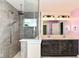 Modern bathroom with glass-enclosed shower, double sinks, and stylish lighting at 1324 Trailside Dr, Greenwood, IN 46143