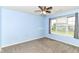 Bedroom featuring neutral carpet, two windows, and a ceiling fan with light fixture at 1324 Trailside Dr, Greenwood, IN 46143