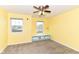 Cozy bedroom with neutral carpet, two windows and a ceiling fan with light fixture at 1324 Trailside Dr, Greenwood, IN 46143