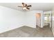 Bright bedroom featuring neutral carpet, white walls, and a ceiling fan with light fixture at 1324 Trailside Dr, Greenwood, IN 46143