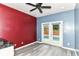 Bonus room featuring hardwood floors, a ceiling fan, and glass doors leading to the in-ground pool at 1324 Trailside Dr, Greenwood, IN 46143