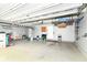 Spacious garage with storage racks, ample lighting, and plenty of room for parking at 1324 Trailside Dr, Greenwood, IN 46143