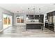Open concept kitchen featuring dark wood cabinets, stainless steel appliances, hardwood floors and an island at 1324 Trailside Dr, Greenwood, IN 46143