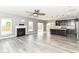 Open concept living and kitchen space, with fireplace, hardwood floors and a large island with pendant lights at 1324 Trailside Dr, Greenwood, IN 46143