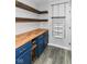 Organized pantry with custom shelving, blue cabinets, and butcher block countertop at 1324 Trailside Dr, Greenwood, IN 46143