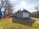 Backyard view featuring a garage with a white door at 2414 W 16Th St, Anderson, IN 46016
