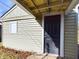 Exterior entrance and siding of home with small window at 2414 W 16Th St, Anderson, IN 46016
