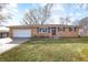 Brick ranch home with attached garage and landscaped lawn at 3052 S Fielding Rd, New Palestine, IN 46163