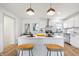 Updated kitchen featuring white cabinets, an island, and hardwood floors at 3052 S Fielding Rd, New Palestine, IN 46163