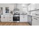 Modern kitchen with white cabinets, stainless steel appliances, and quartz countertops at 3052 S Fielding Rd, New Palestine, IN 46163