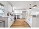 White kitchen with stainless steel appliances and hardwood floors at 3052 S Fielding Rd, New Palestine, IN 46163