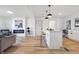 Bright living room with hardwood floors and a kitchen island at 3052 S Fielding Rd, New Palestine, IN 46163