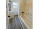 Bathroom featuring a shower and tub combo, a white vanity and modern style mirror at 310 S Gerrard Dr, Indianapolis, IN 46241