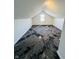 Attic bedroom featuring neutral paint, natural light from one window and modern black and gray carpet at 310 S Gerrard Dr, Indianapolis, IN 46241