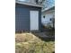 A white back door provides access to the home's exterior in a backyard setting at 310 S Gerrard Dr, Indianapolis, IN 46241