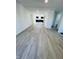 Spacious living room with gray laminate flooring that leads into the kitchen at 310 S Gerrard Dr, Indianapolis, IN 46241