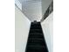 Staircase with black-painted wood steps leading to a dark upstairs at 310 S Gerrard Dr, Indianapolis, IN 46241