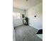 Utility room with a water heater, tiled flooring and a window at 310 S Gerrard Dr, Indianapolis, IN 46241