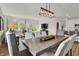 Dining room featuring a wooden table, six chairs, and a modern light fixture that opens to the living room and kitchen at 3783 Sunset Ridge Dr, Franklin, IN 46131