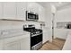 Well-equipped kitchen with stainless steel appliances, gas range, white cabinets, and wood-look flooring at 3783 Sunset Ridge Dr, Franklin, IN 46131