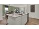 Open kitchen island features seating, stainless steel dishwasher, and seamless flow to dining and living area at 3783 Sunset Ridge Dr, Franklin, IN 46131