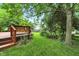 Serene backyard featuring a wooden deck, a lush lawn and mature trees at 4646 Rocky Knob Ln, Indianapolis, IN 46254