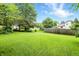 Large, green backyard with a lush lawn, mature trees, and a fence outlining the property at 4646 Rocky Knob Ln, Indianapolis, IN 46254