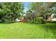 Well-manicured backyard featuring a wooden deck, lush green grass, and mature trees at 4646 Rocky Knob Ln, Indianapolis, IN 46254