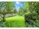 Expansive backyard with a well-maintained lawn, mature trees, and privacy fence at 4646 Rocky Knob Ln, Indianapolis, IN 46254