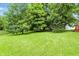 Lush backyard with mature trees and well-maintained lawn, offering privacy and space at 4646 Rocky Knob Ln, Indianapolis, IN 46254