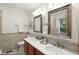 Bathroom with a dual sink vanity, decorative mirrors, and tile floors at 4646 Rocky Knob Ln, Indianapolis, IN 46254