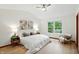 A bright bedroom with a ceiling fan, artwork, and a large window at 4646 Rocky Knob Ln, Indianapolis, IN 46254